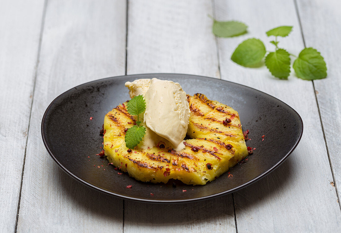 Grilled pineapple with pink pepper, vanilla ice cream and lemon balm