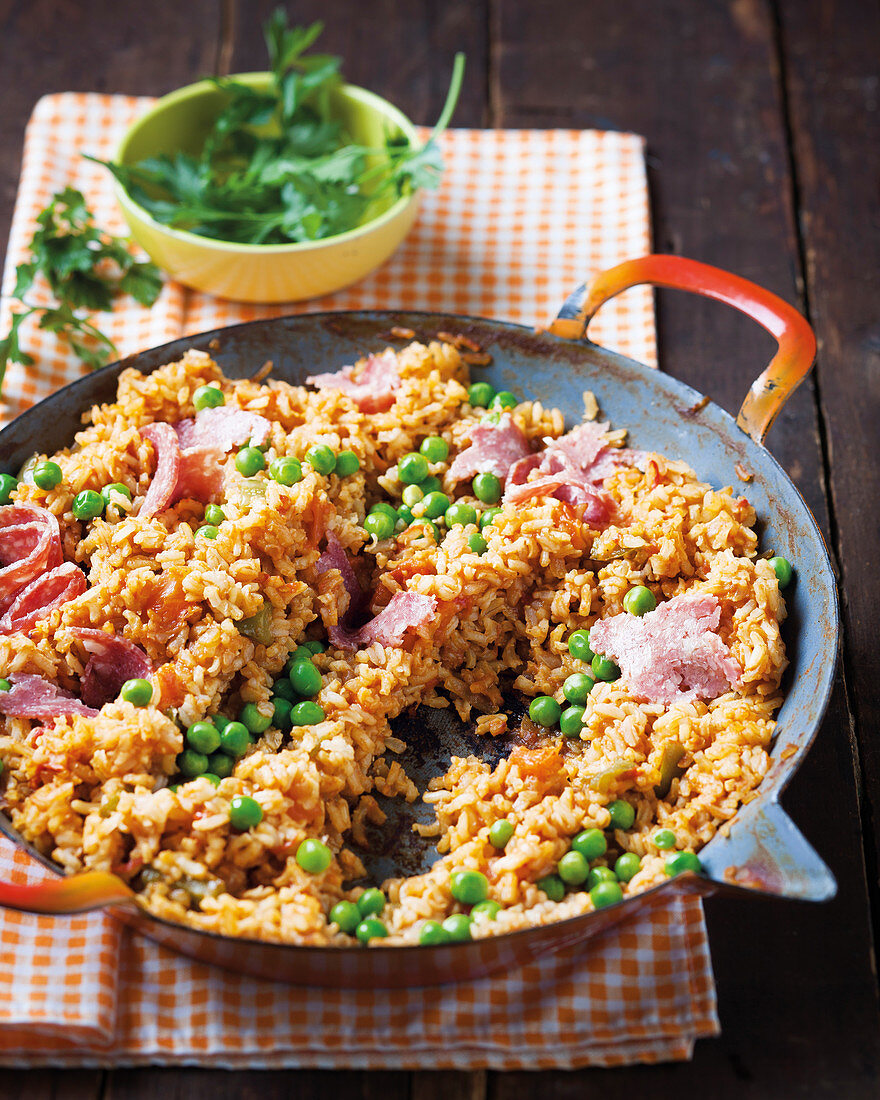 Fried red rice with tomatoes and peas