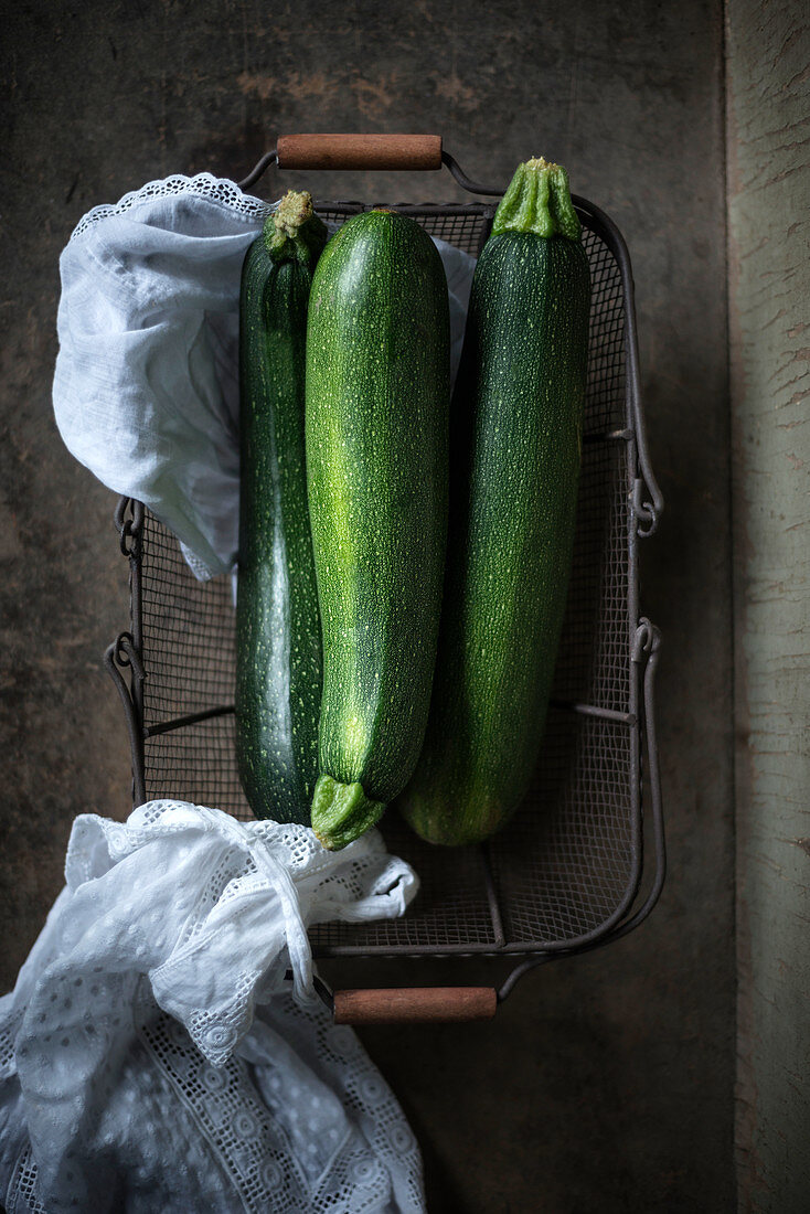 Drei Zucchini im Drahtkorb