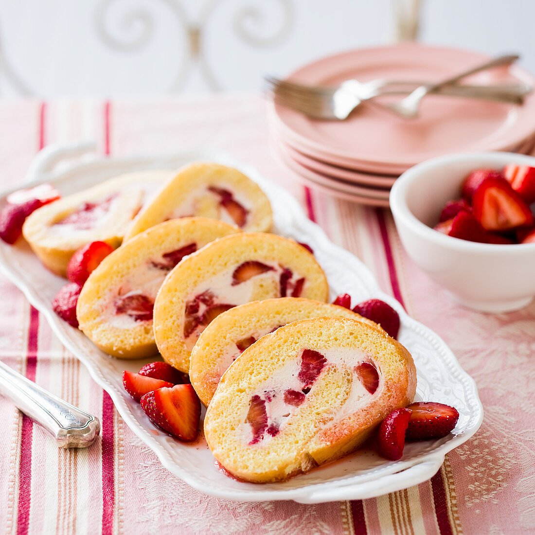 Strawberry and cream Swiss roll, sliced