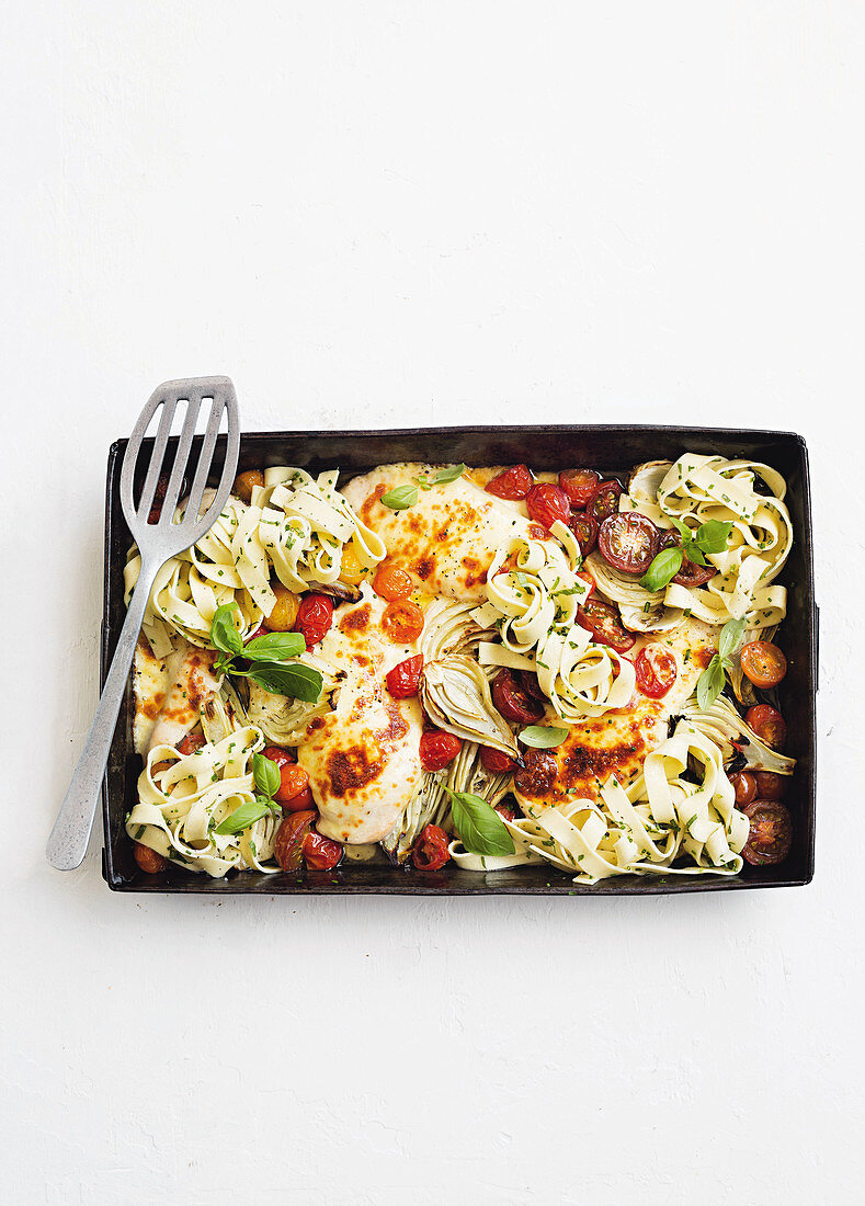 Chicken with herb pasta on a baking tray