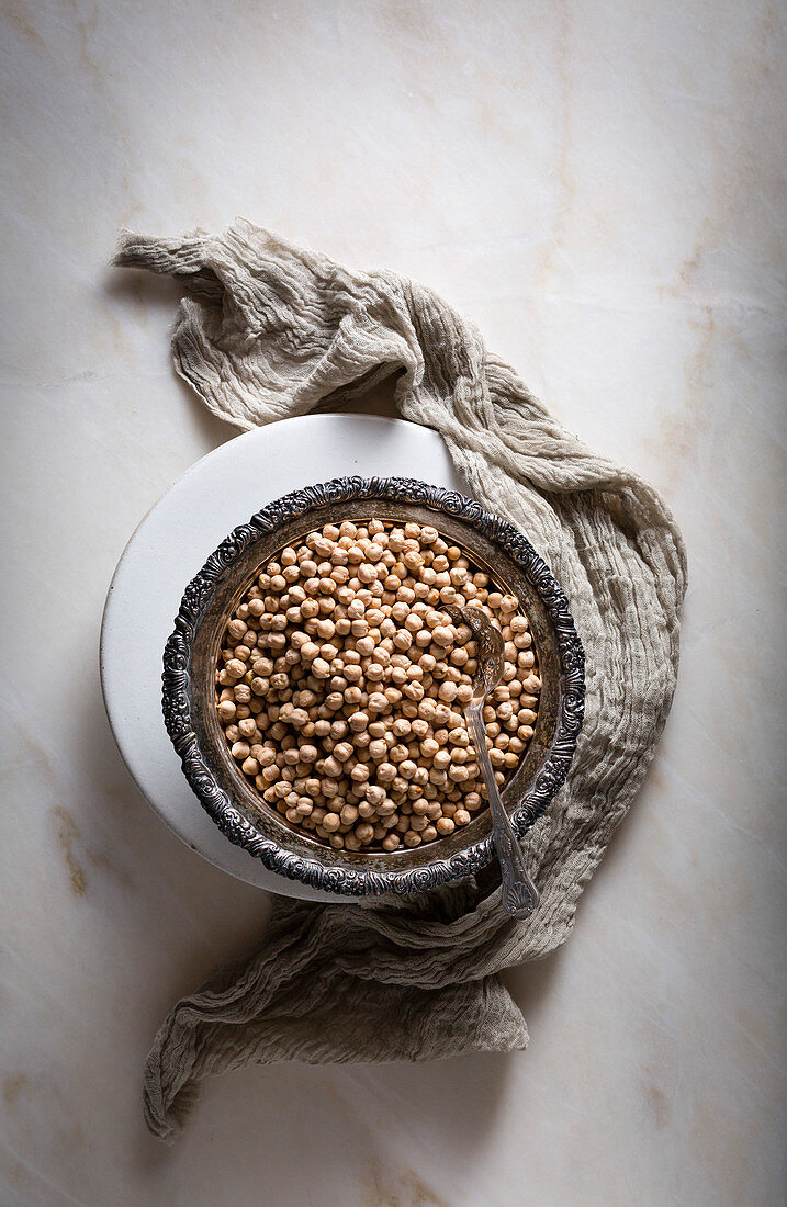 Raw chickpeas in a silver bowl