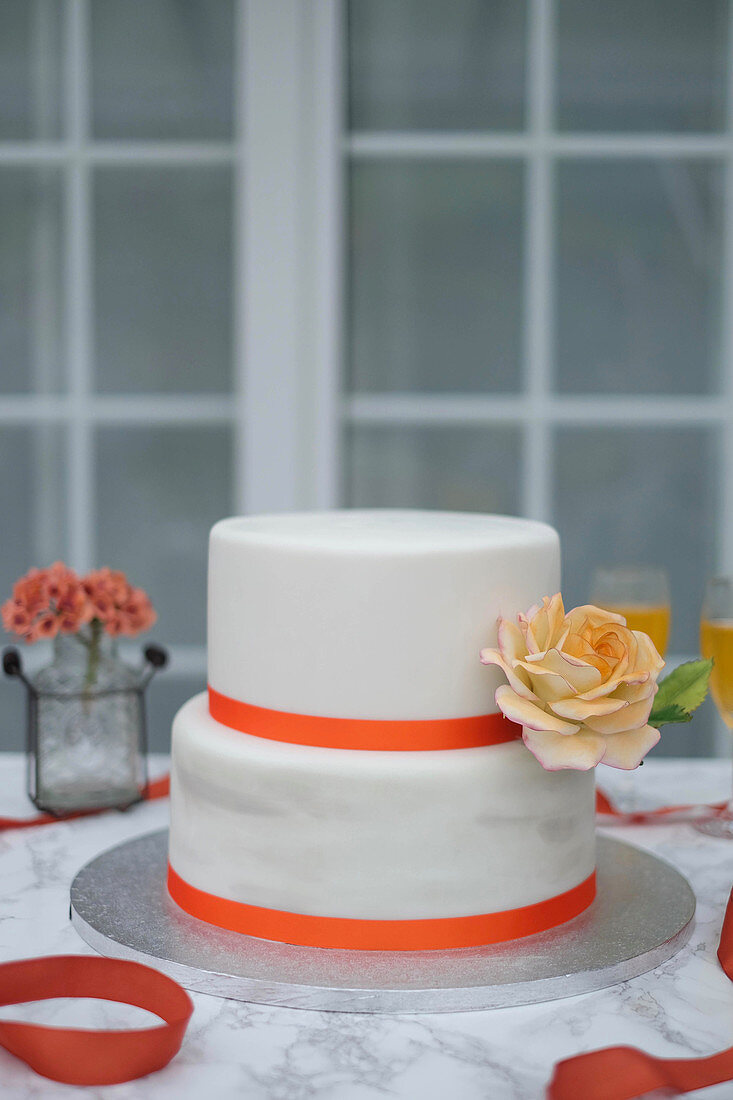 A two-tier wedding cake decorated with roses