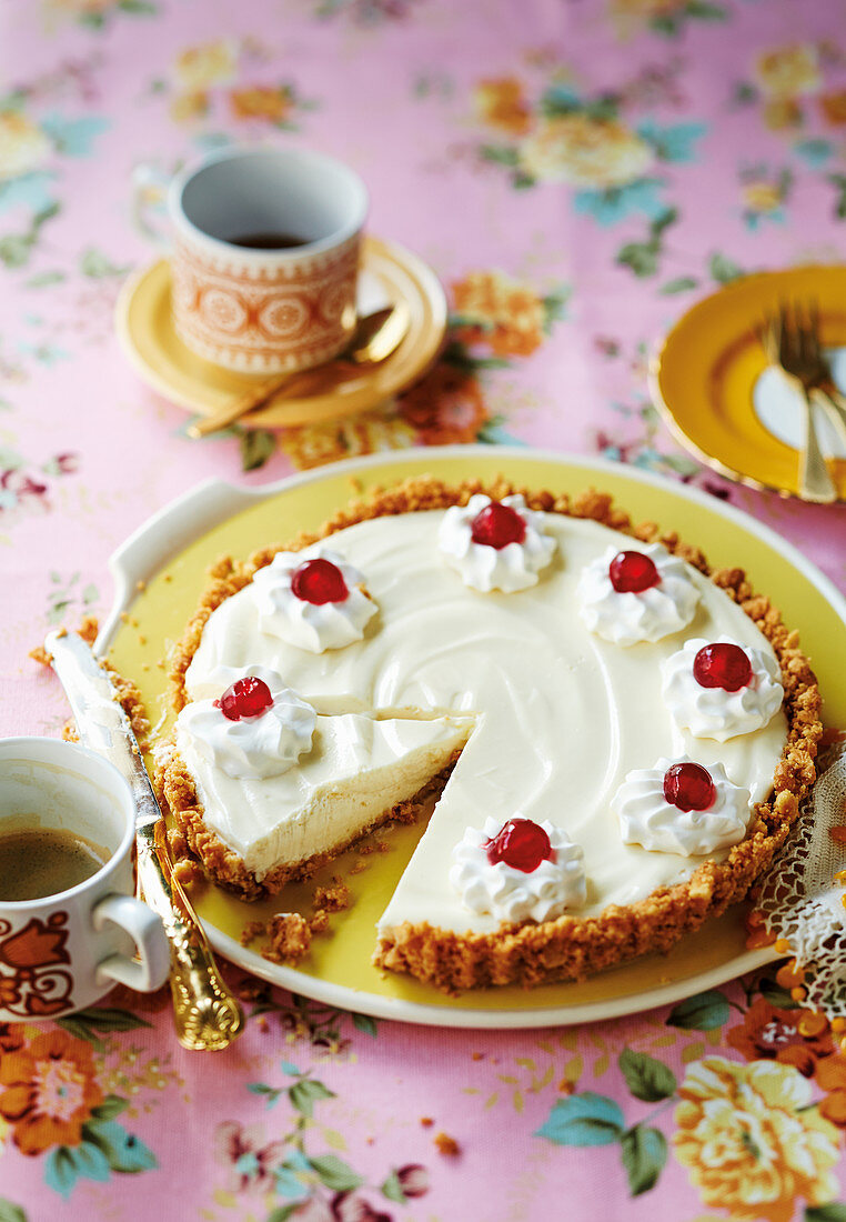 Milk powder cake with a crumb base and glace cherries