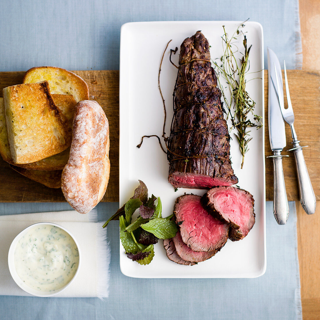 Rare roasted beef fillet with bread and sauce