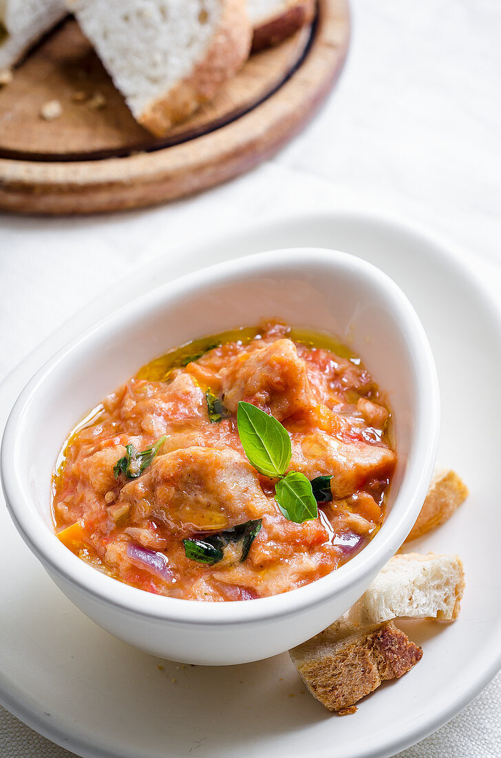 Pappa al pomodoro (bread and tomato soup, Italy) with red onions and basil