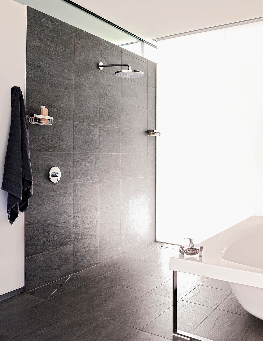 Floor-level shower with grey tiles in modern bathroom