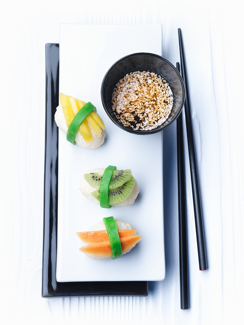 Sweet sushi with a sesame and honey dip