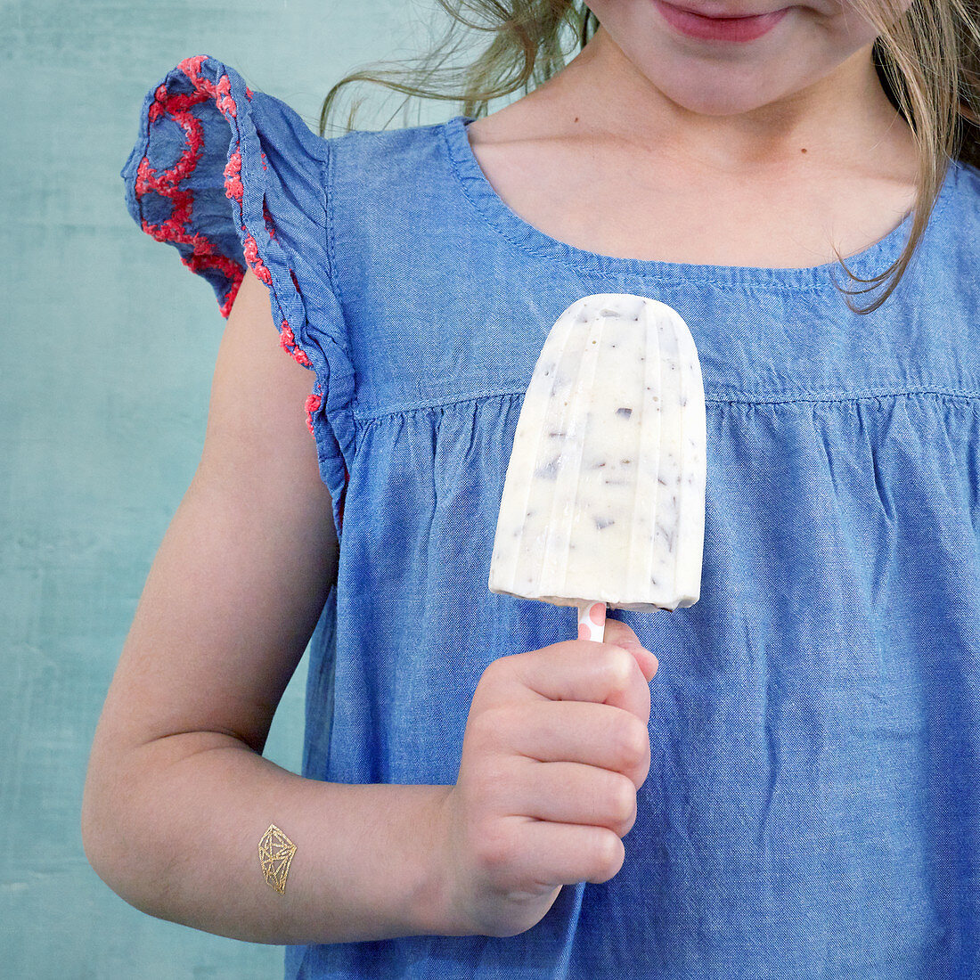 Kleines Mädchen hält Bananen-Stracciatella-Eis