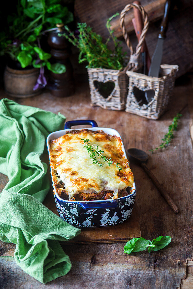 Baked potatoes, mushrooms, pork chops under cheese crust