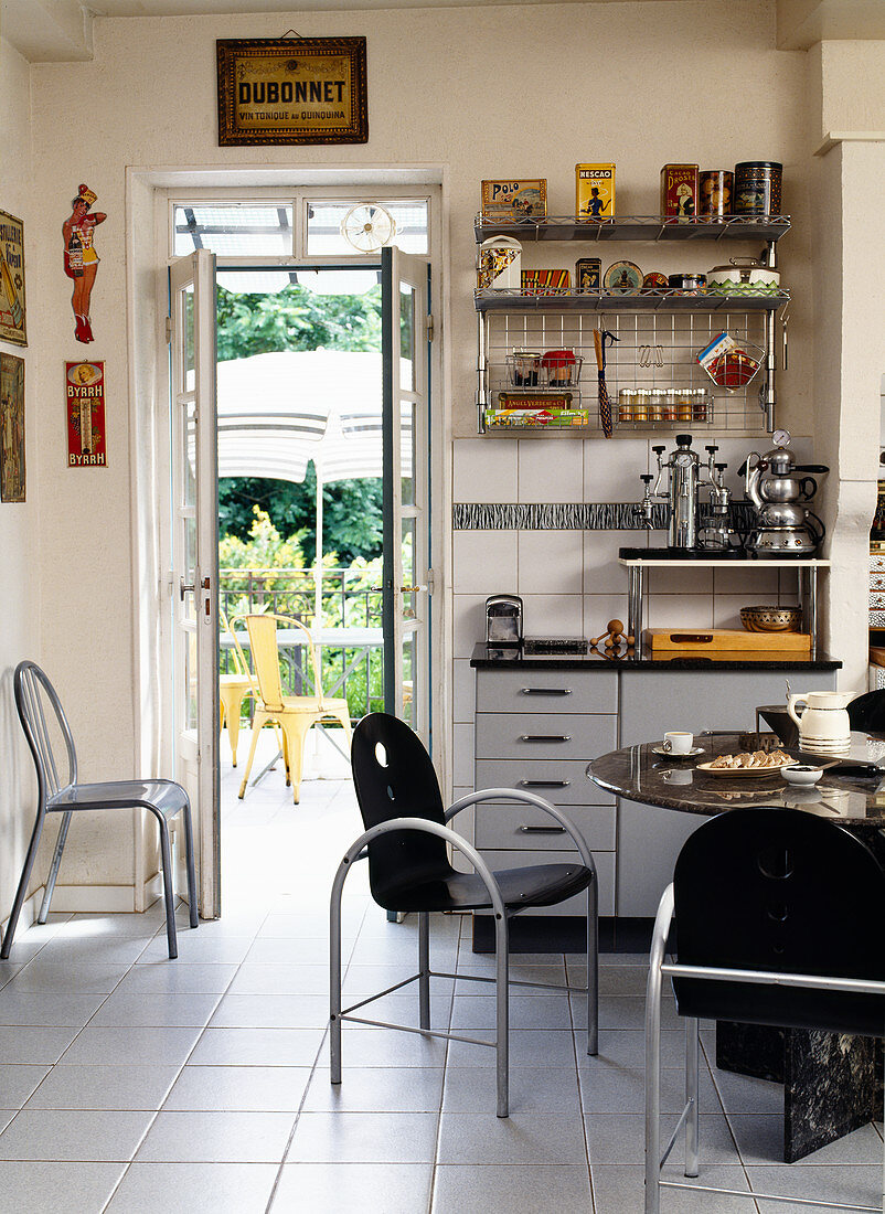 Dining area and eclectic mix of 80s and vintage furniture in kitchen