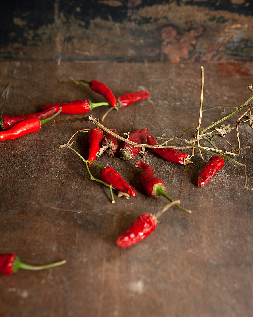 Red chili peppers on a rustic wooden background