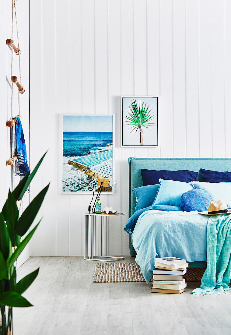 Bedroom with accessories in aqua tones and white wooden paneling