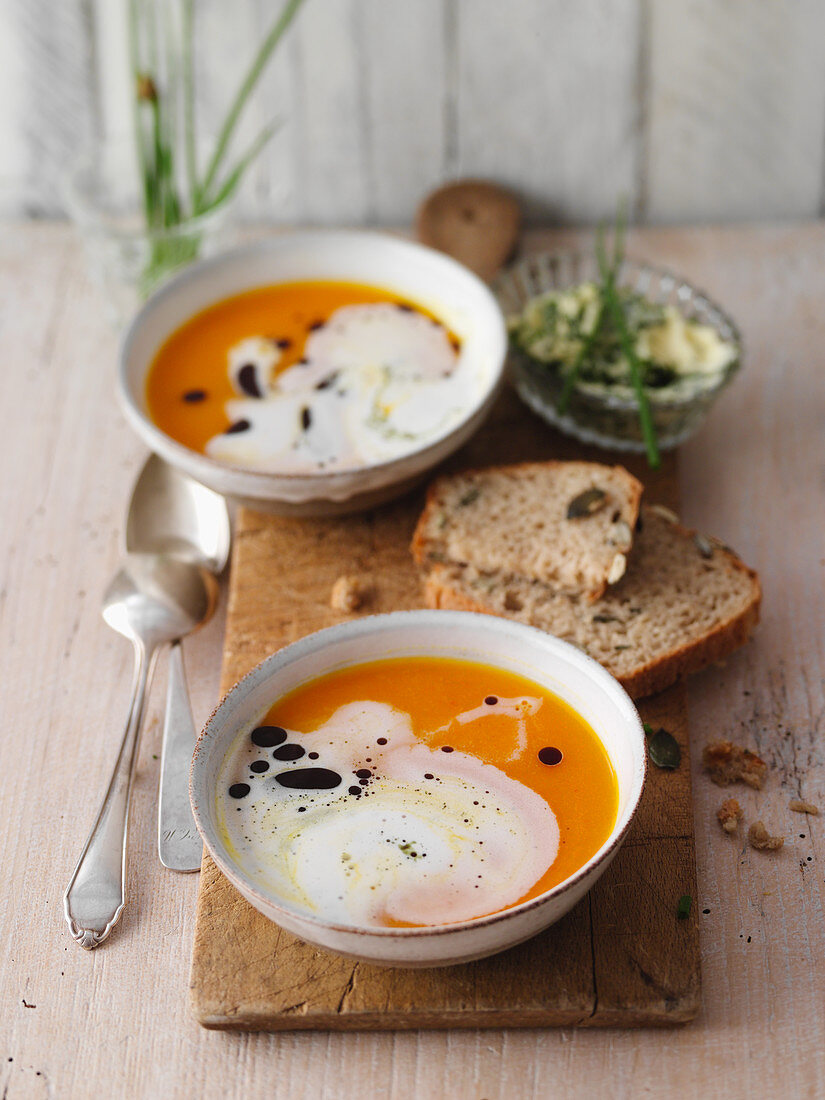 Pumpkin soup with pumpkin seed bread and herb butter