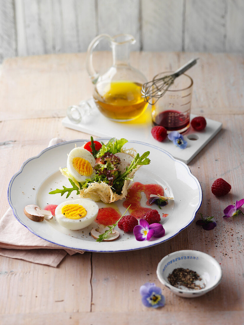 A boiled egg with a colourful salad in a parmesan nest