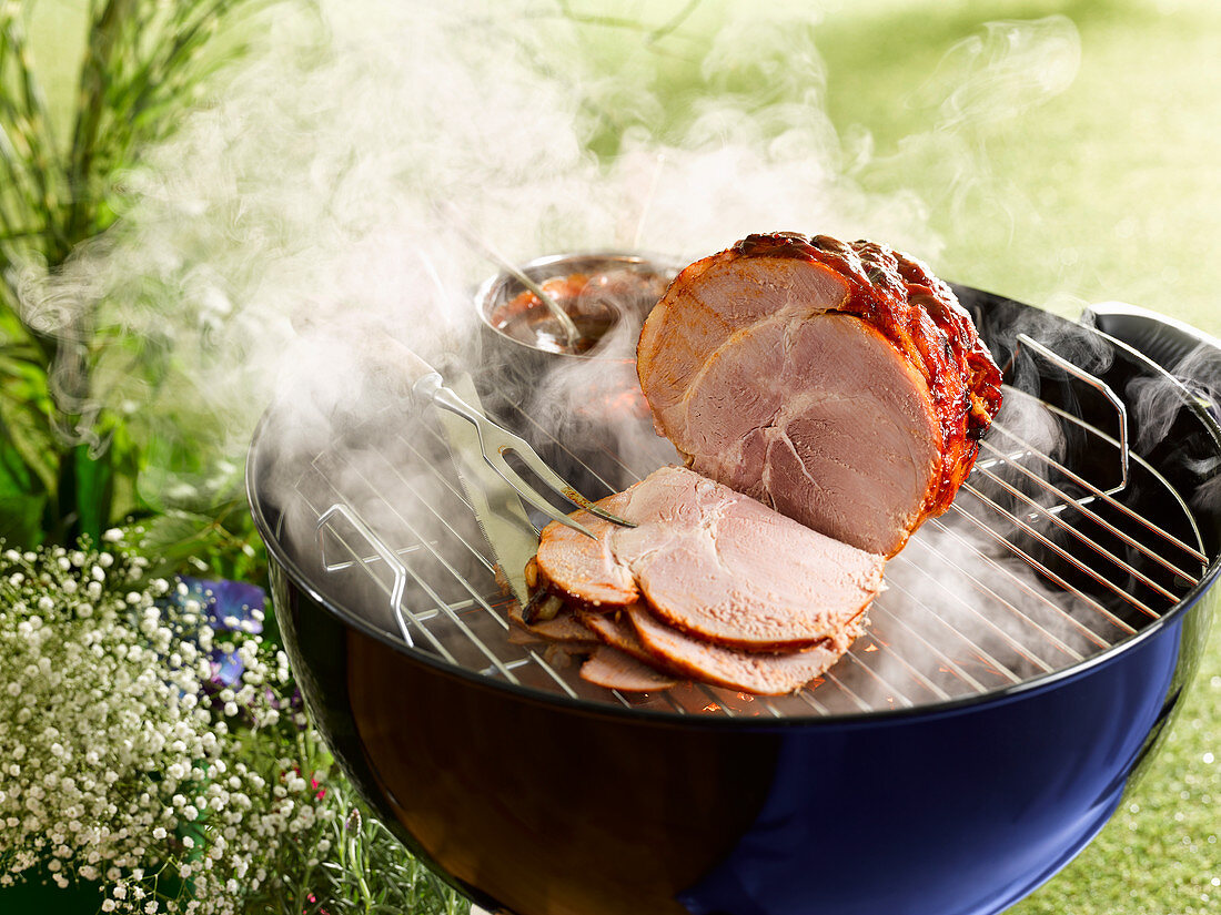 Hot smoked ham on a grill