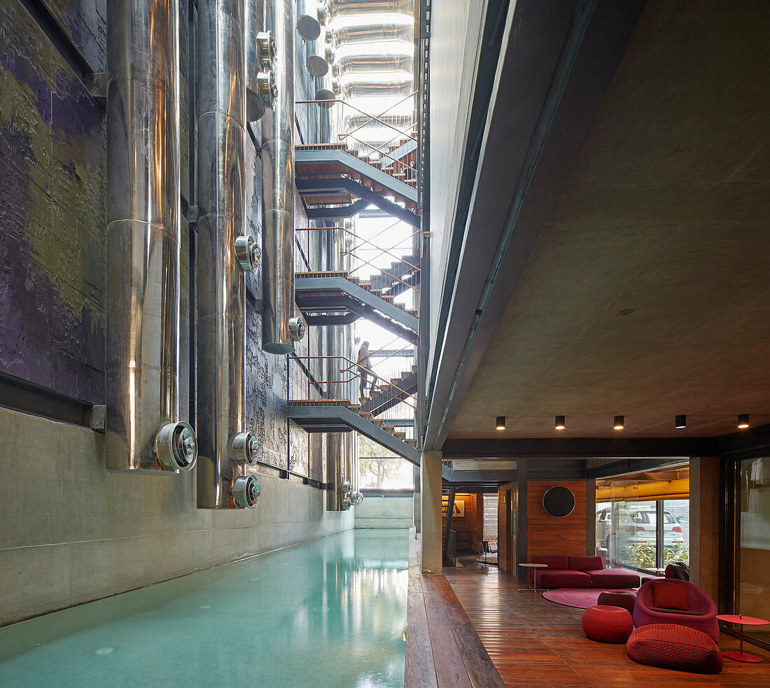 Ducts and stairs above pool in modern architect-designed house