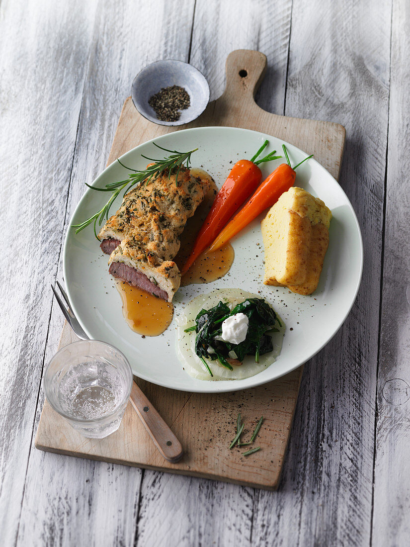 Saddle of lamb with carrots, spinach and potato pudding
