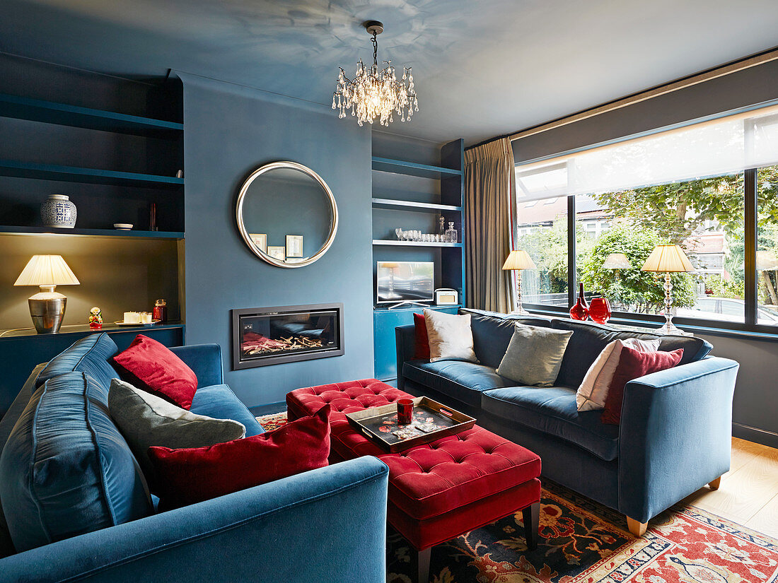 British-style living room in blue and red with fitted shelves