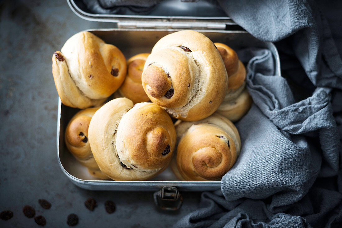 Vegan raisin buns in a tin box