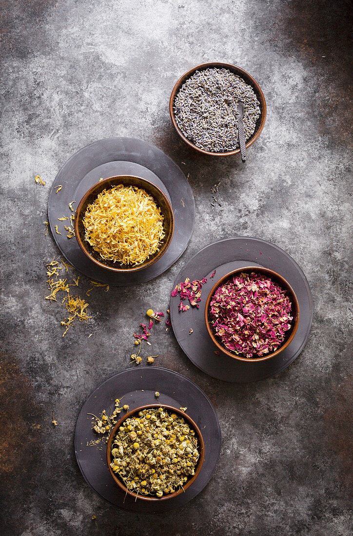Dried flowers - Lavender, chamomile, rose and marigold on a cookie sheet background