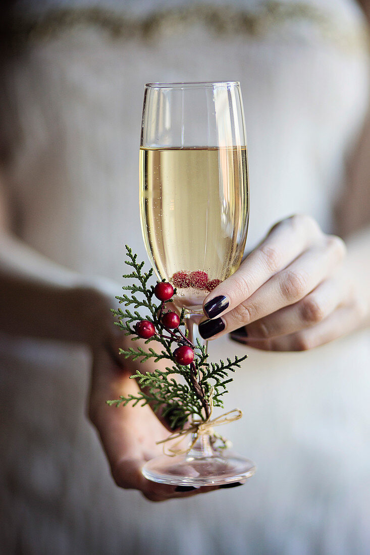 Young woman holding in her hands a glass of champagne