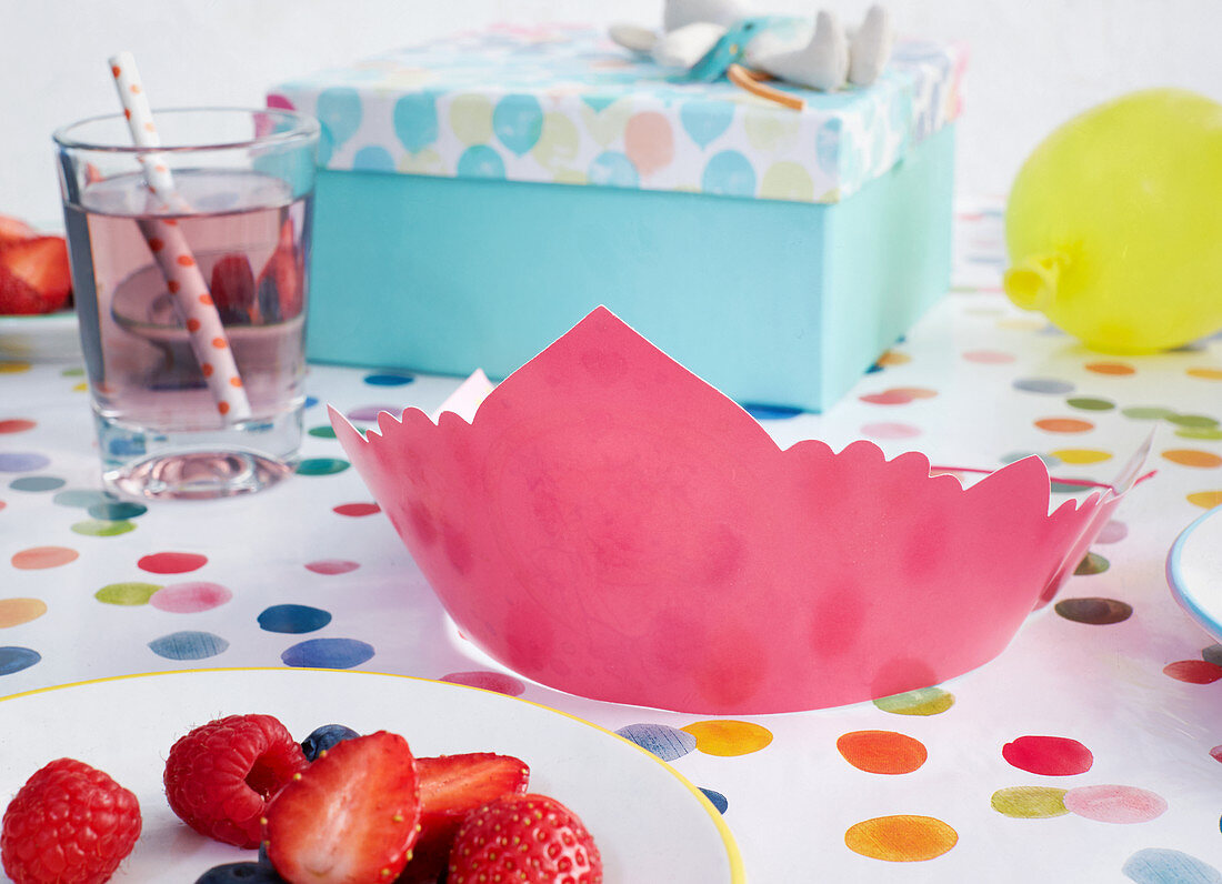 A birthday crown on a table laid for a child's birthday