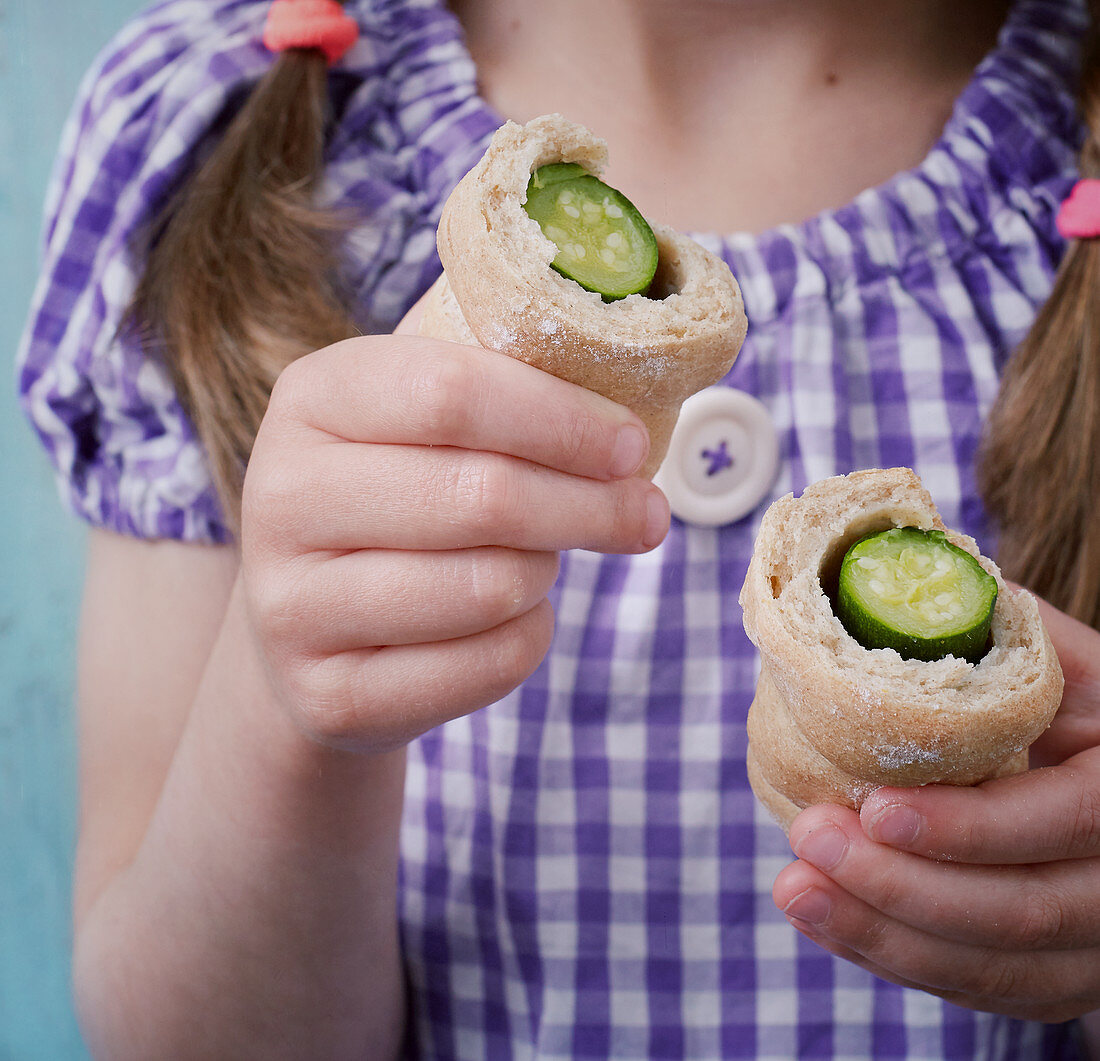 Baguette filled with mini frankfurters, mini courgettes and feta cheese