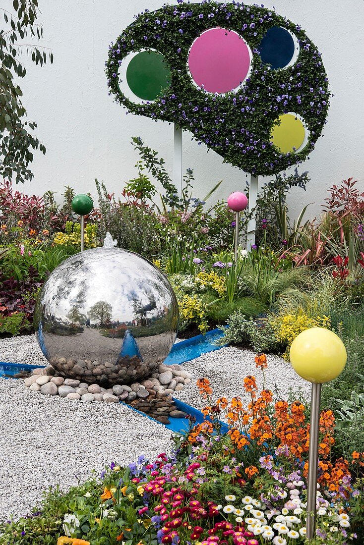Contemporary show garden with spherical water feature