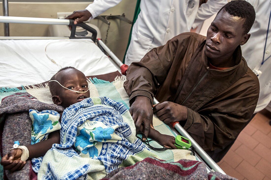 Father with sick child in hospital