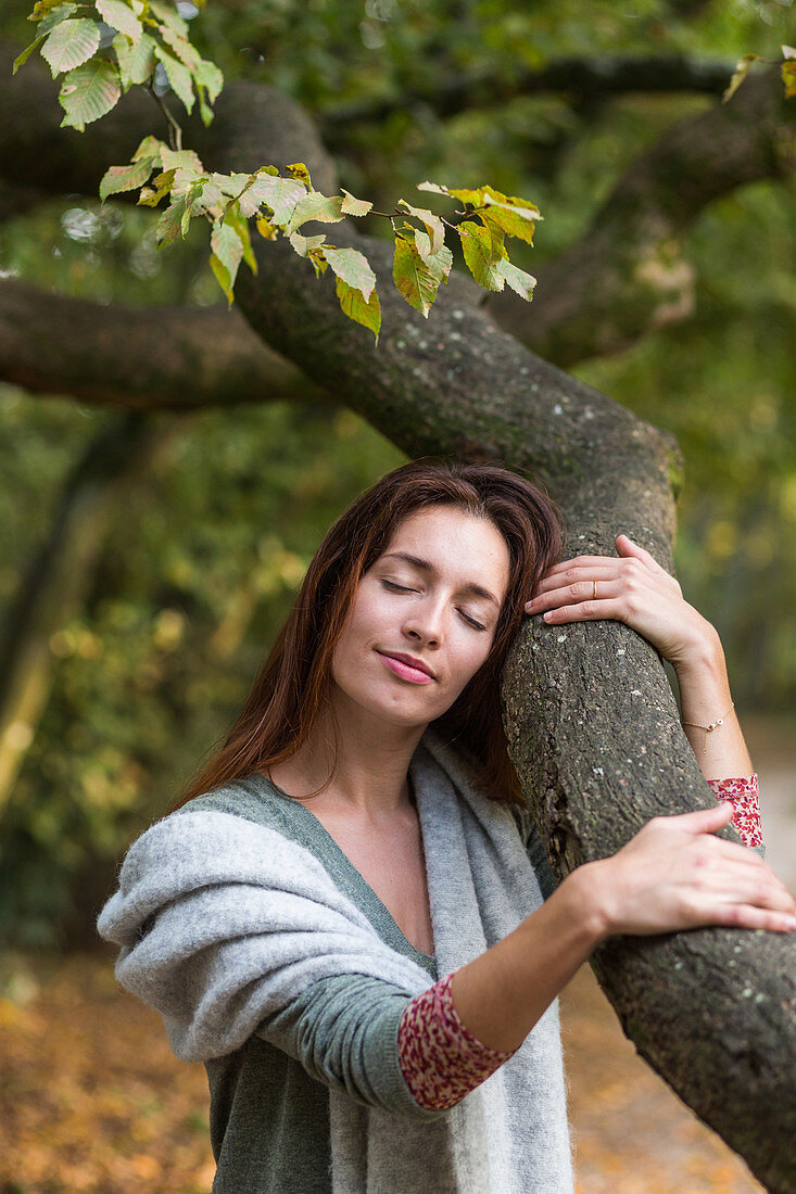 Woman hugging a tree