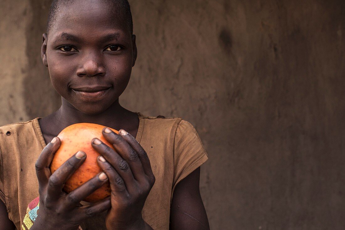 Boy holding fruit