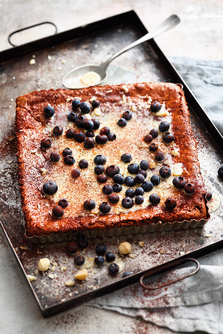 Grilled macadmaia nut cake with chocolate cream and blueberries