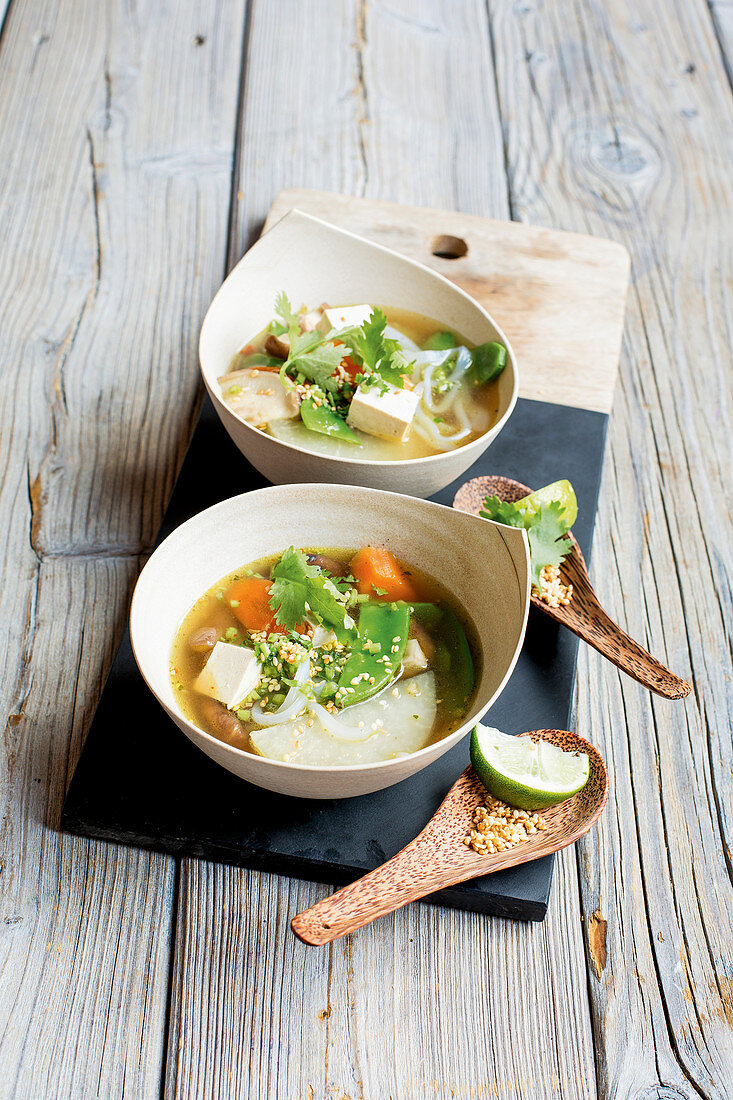 Asian vegetable soup with rice noodles and tofu