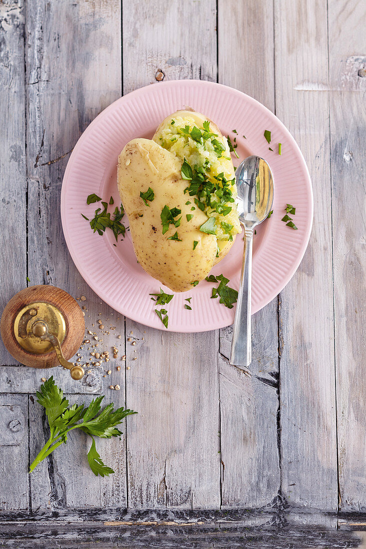 A baked potato with parsley