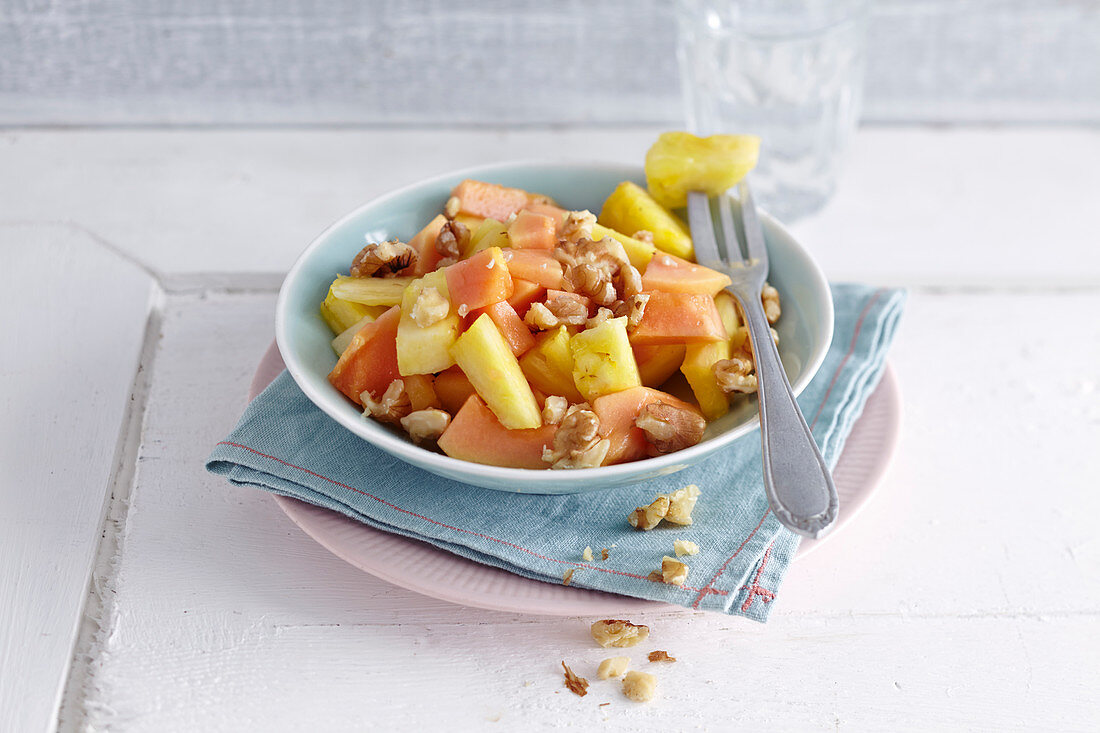 Papaya and pineapple salad with walnuts for breakfast
