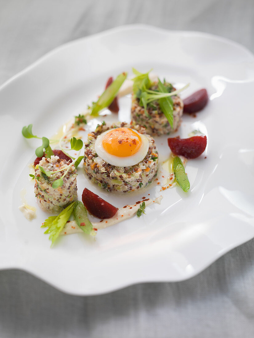 Vegetable and quinoa tatar with a fried quail's egg