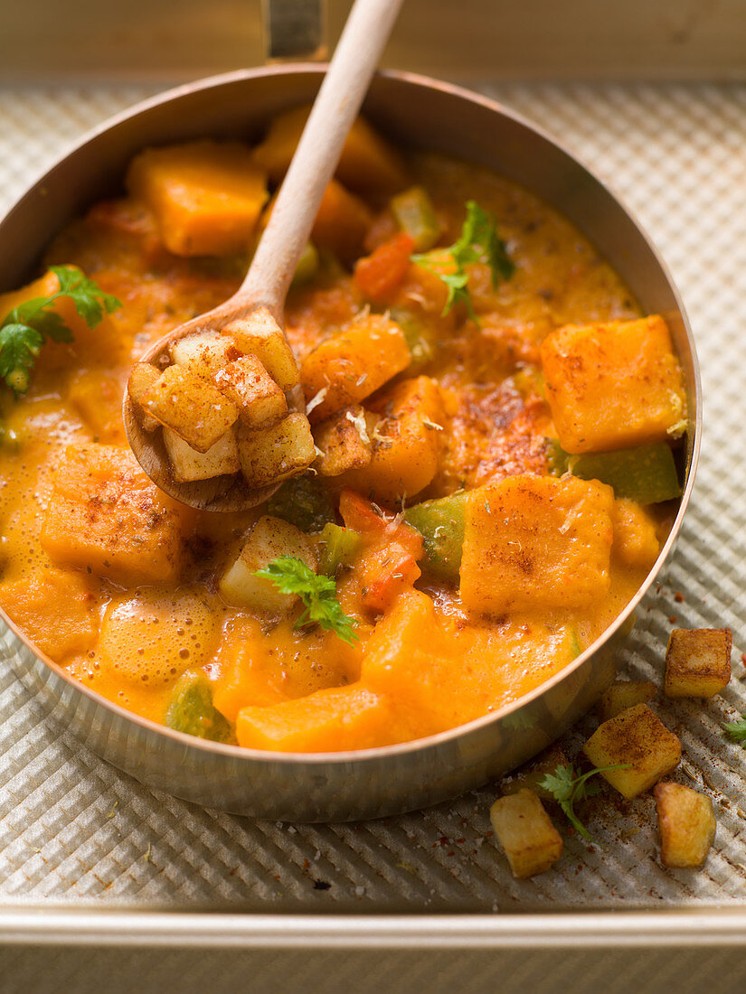 Pumpkin cream goulash with potato cubes