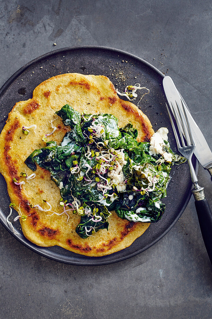 Millet pancake with a spinach and bean sprout topping