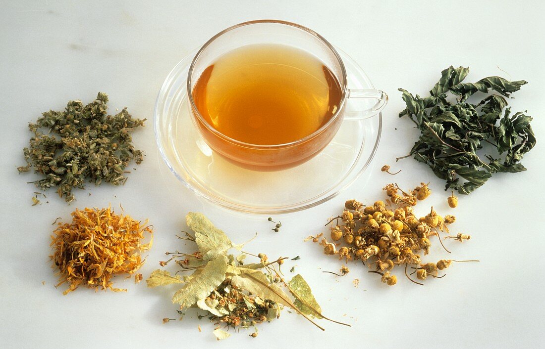 A Cup of Tea Surrounded by Loose Tea