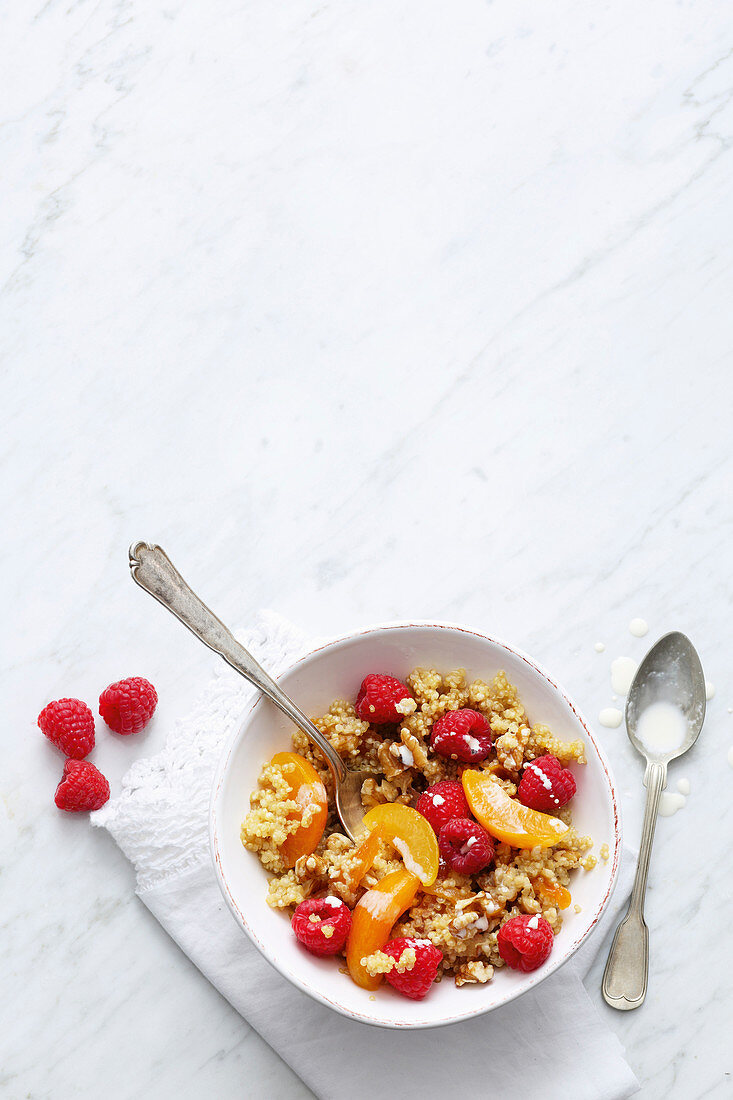 Vegan quinoa muesli with apricots, raspberries and soya yoghurt