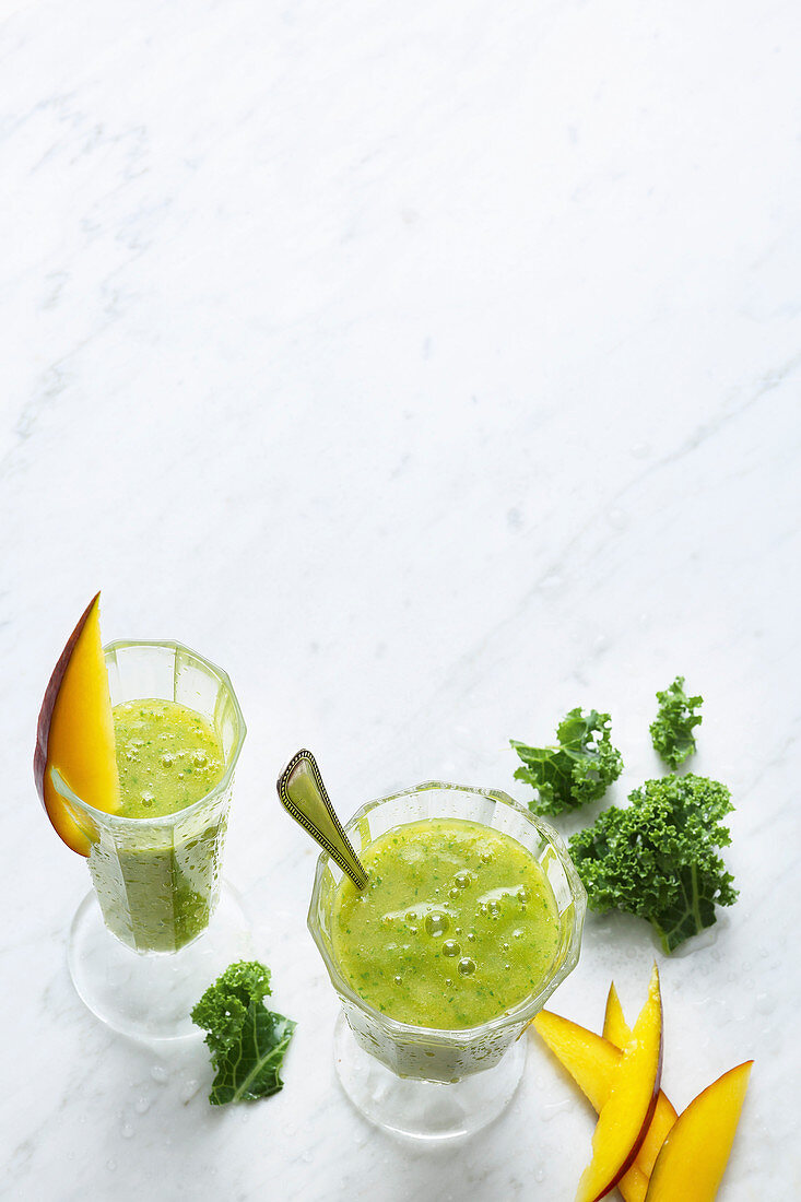 Tropical smoothies with kale, mango, dates and coconut water