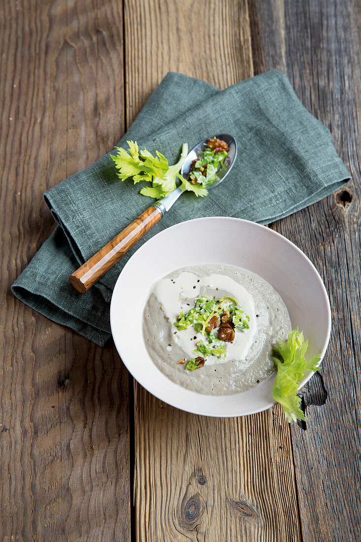 Cream of mushrooms soup garnished with walnuts