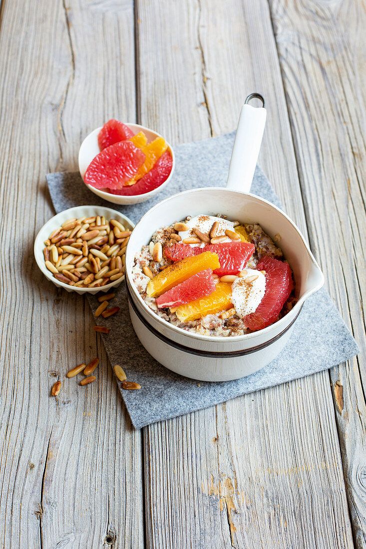 Oat porridge with citrus fruit and pine nuts