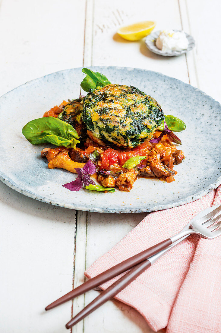 Spinach fritters with a mushroom and tomato sauce
