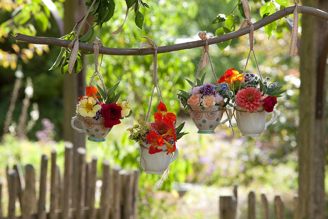 Mini bouquets in small cups as a hanging decoration