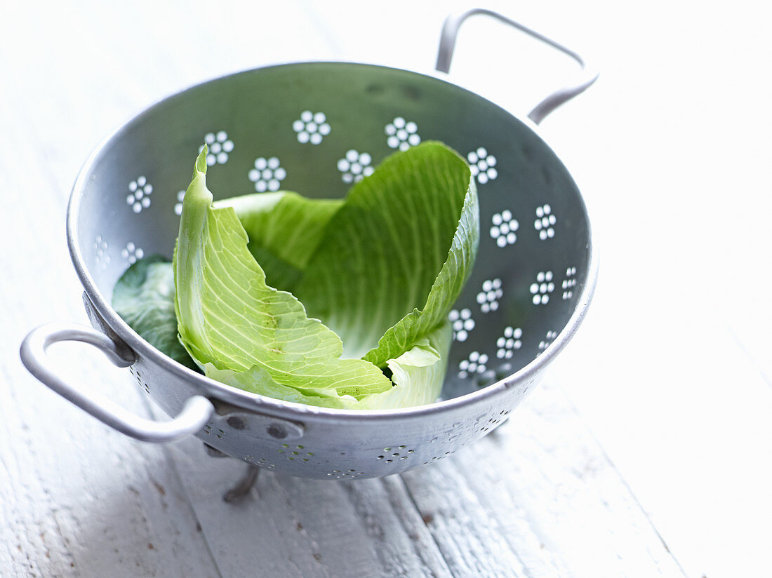 White cabbage leaves in a colander