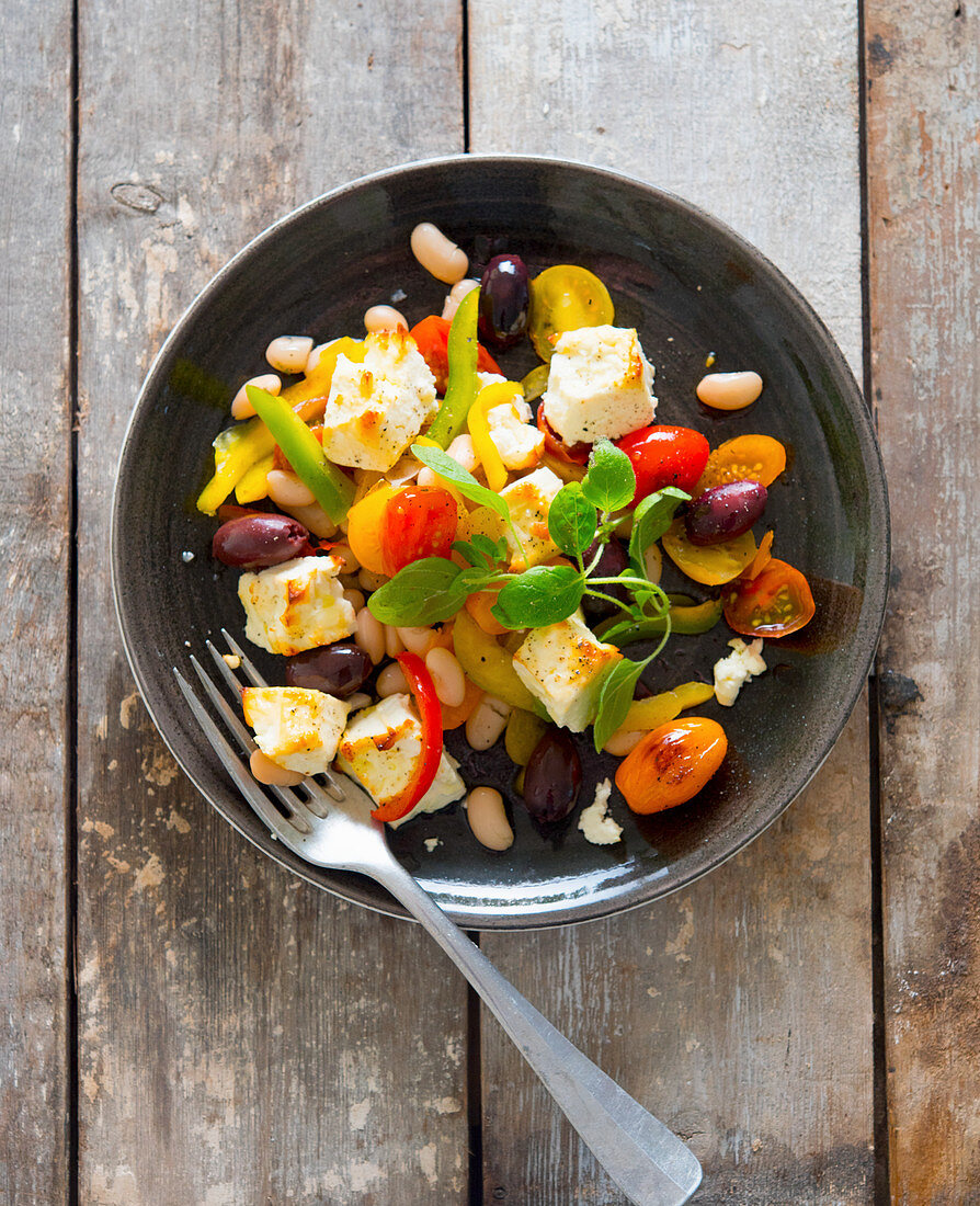 Sheep's cheese salad with tomatoes, olives and pepper