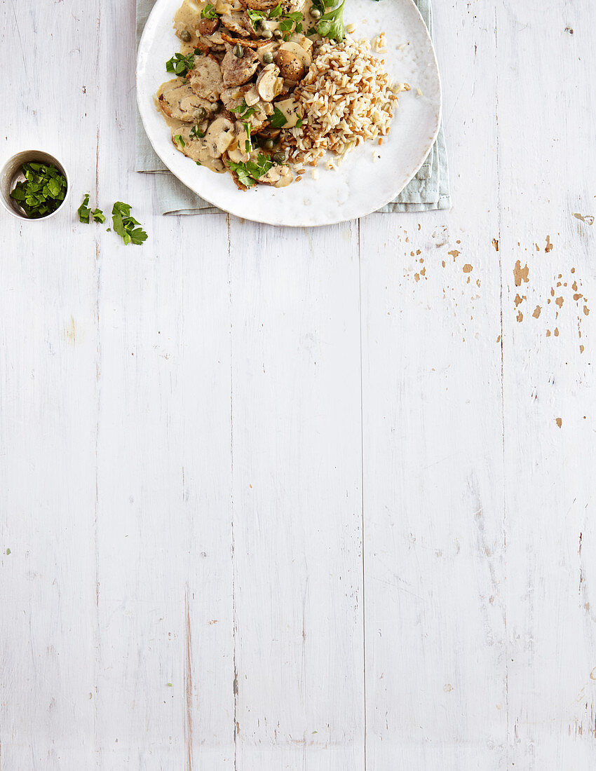 Pork fillets in mushroom sauce with farro rice