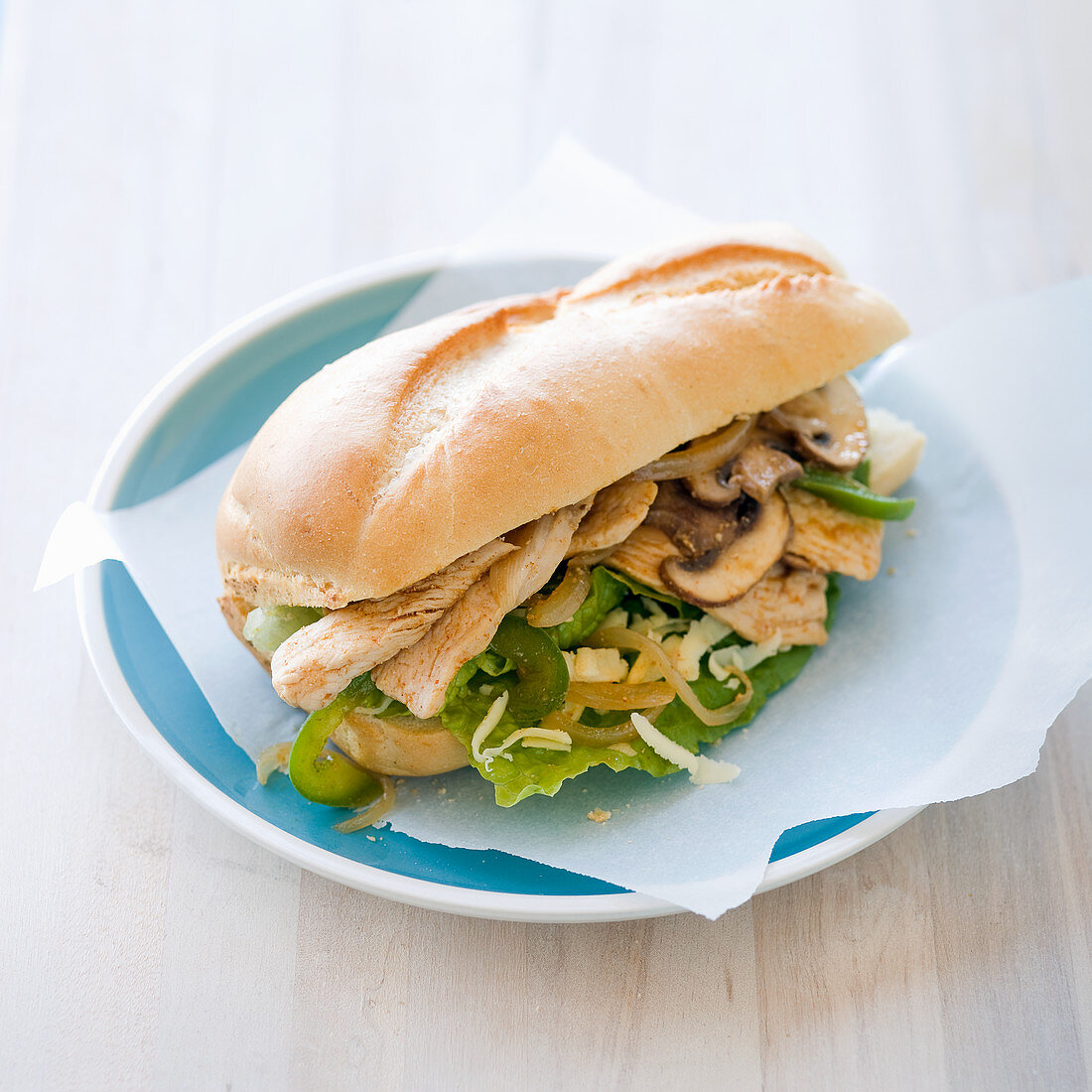 Chicken submarine sandwich with onions, mushrooms and bellpepper